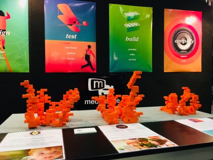 Media Suite stand at the Tech Summit with the final lego creations on a table