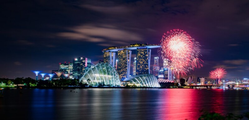 Fireworks in Singapore over sky scrapers and water