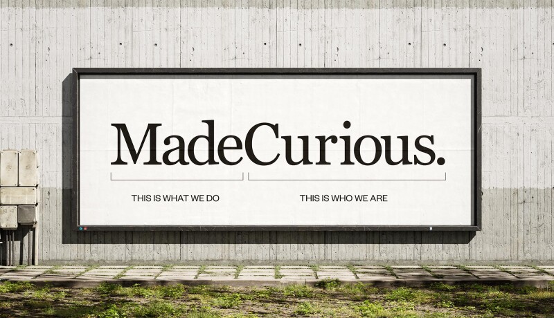 MadeCurious Logo on a billboard with "this is what we do" under the word "made" and "This is who we under the word "Curious