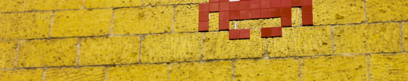 space invader on yellow wall