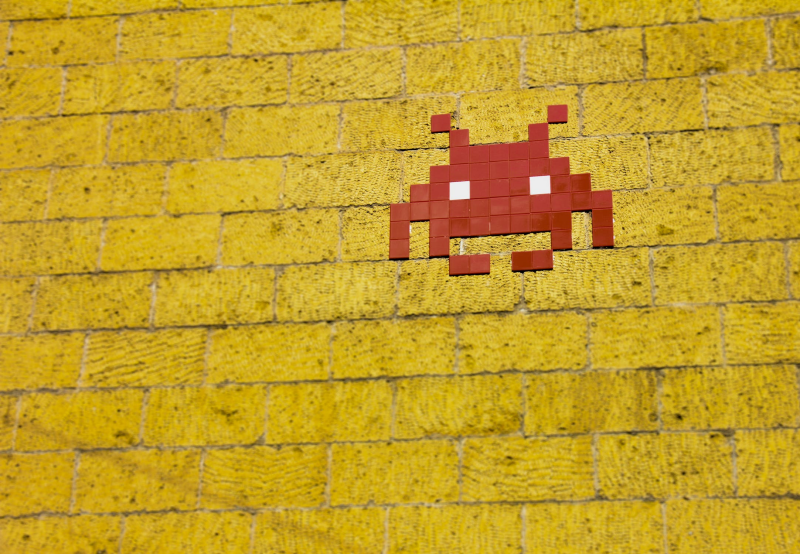 space invader on yellow wall