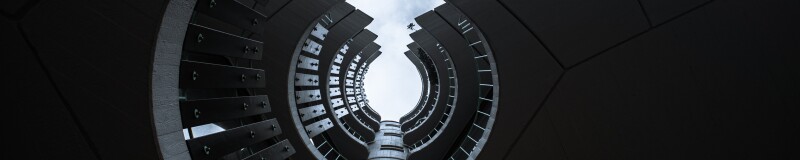 View from the base of a building looking up at the curves of the balconies