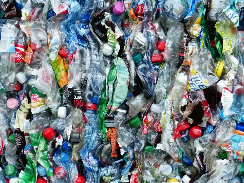 Hundreds of squashed plastic bottles in many colours