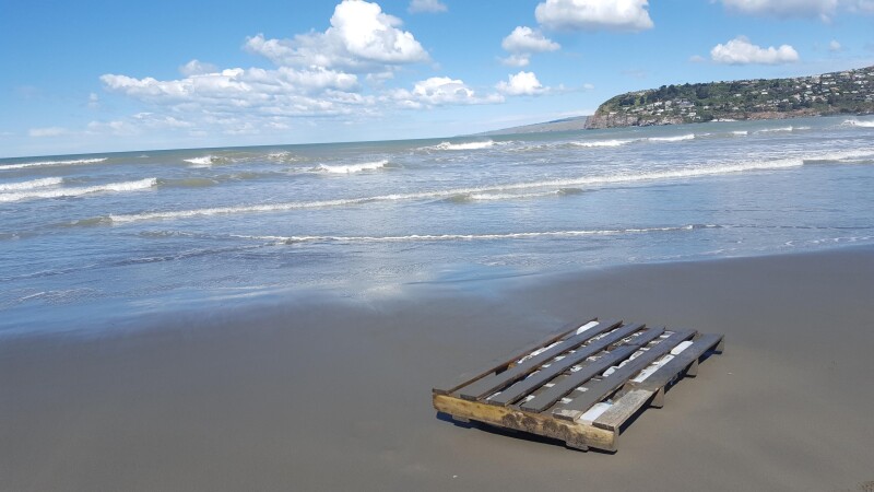 Pallet on the beach, looking out to see with headland in distance on the right