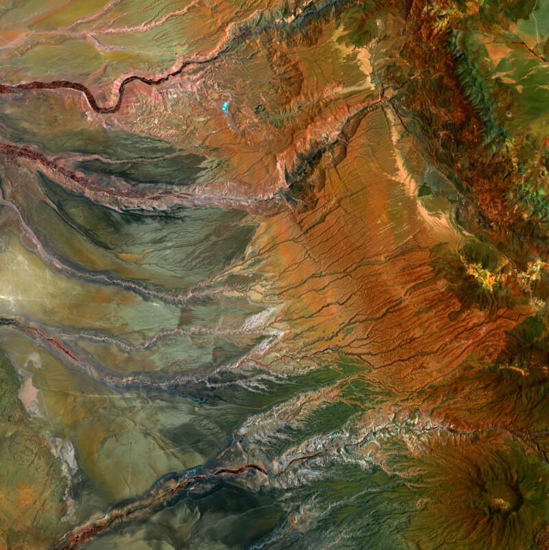 Aerial view of the valleys carved by water flowing from the Andes Mountains in northern Chile and the volcano Cerro Guachiscota.