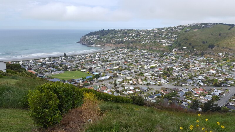 View from a hilltop looking down on a beach-side community (Sumner in Christchurch))