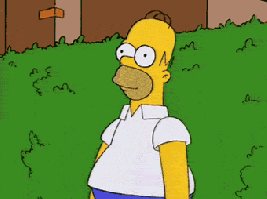 Gif of Homer Simpson slowly moving backwards into a green hedge until he is no longer visible