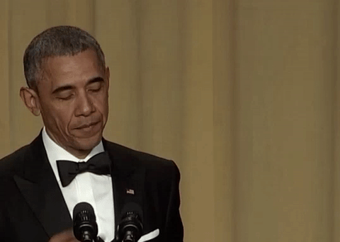 Gif of Barack Obama in a tuxedo dropping a mic with his left hand and kissing the second and third fingers of his right hand 