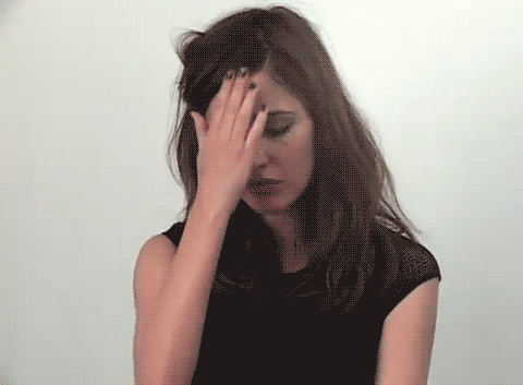 Gif of actor Rose Byrne doing the sign of the cross and putting her hands in prayer in front of her