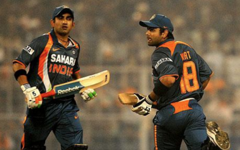 Gautam Gambhir (left, facing camera) Virat Kohli (right facing away), batsmen for India, running past each other