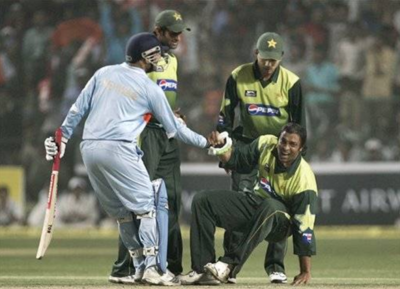 Sehwag (Indian Batsman) helping Akhtar (Pakistan bowler) to his feet after he fell to the ground.