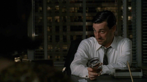 Gif of Don Draper from Mad Med holding a glass of whisky, which sloshing around slightly in the glass
