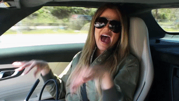 Gif of a Kardashian in the passenger seat of a moving car, shaking her hands in an excitable way
