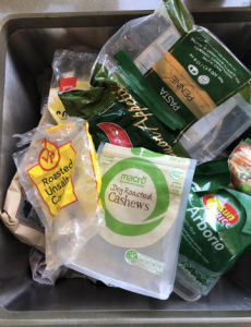 Various pieces of plastic food packaging in a bin